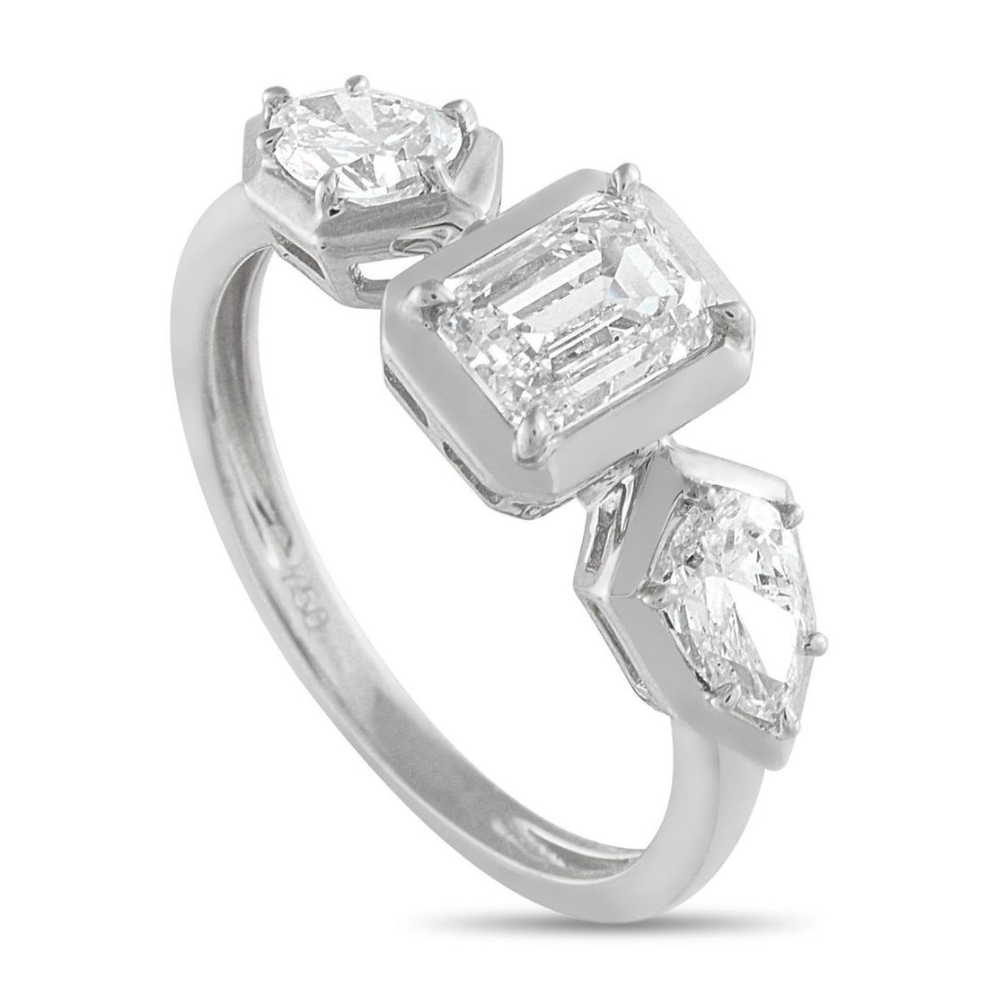 18K WHITE GOLD 1.76CT DIAMOND GEOMETRIC THREE-STONE RING: This dazzling ring is stylish and sophisticated. A 1.01 carat emerald cut Diamond makes a statement at the center of the 18K White Gold setting. Pear-shaped Diamonds totaling 0.75 carats flank the cen