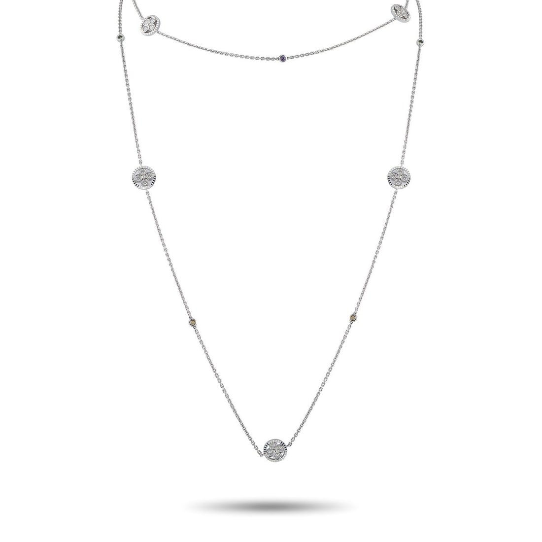 LOUIS VUITTON 18K WHITE GOLD 1.40CT DIAMOND AND RUBY NECKLACE: This Louis Vuitton necklace is both delicate and dramatic. The simple 18K White Gold chain is elevated by subtle Ruby accents, stylish circular motifs, and Diamonds totaling 1.40 carats. It measures 3