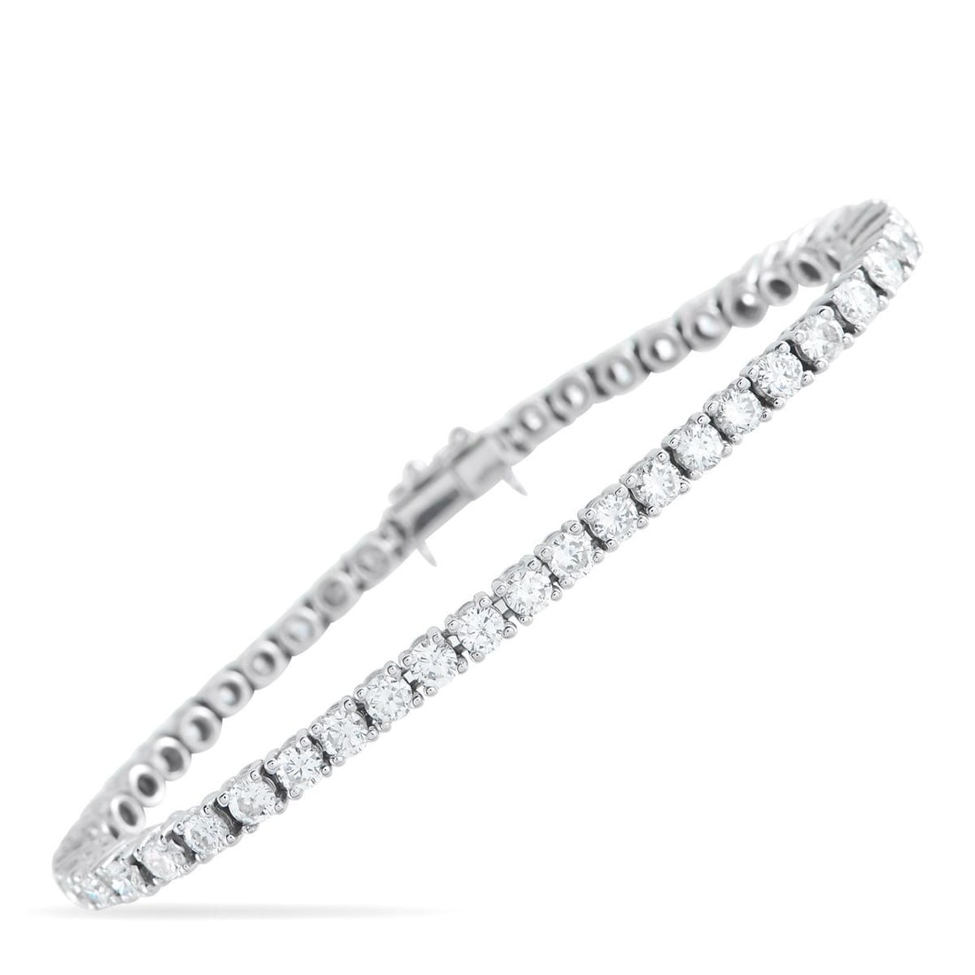 18K WHITE GOLD 6.35CT DIAMOND TENNIS BRACELET: This 18K White Gold tennis bracelet will never go out of style. Elegant and ideal for any occasion, a series of round-cut Diamonds totaling 6.35 carats make it simply unforgettable. It measures 7.0 lo