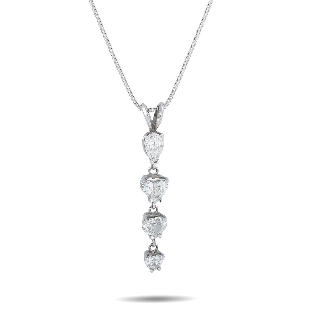 14K WHITE GOLD 2.0CT DIAMOND DROP PENDANT NECKLACE: An elegant pendant necklace in 14K white gold, featuring four graduating heart-shaped diamonds suspended in a vertical drop totaling 2.0 carats. Each diamond is individually prong-set in a white gold 