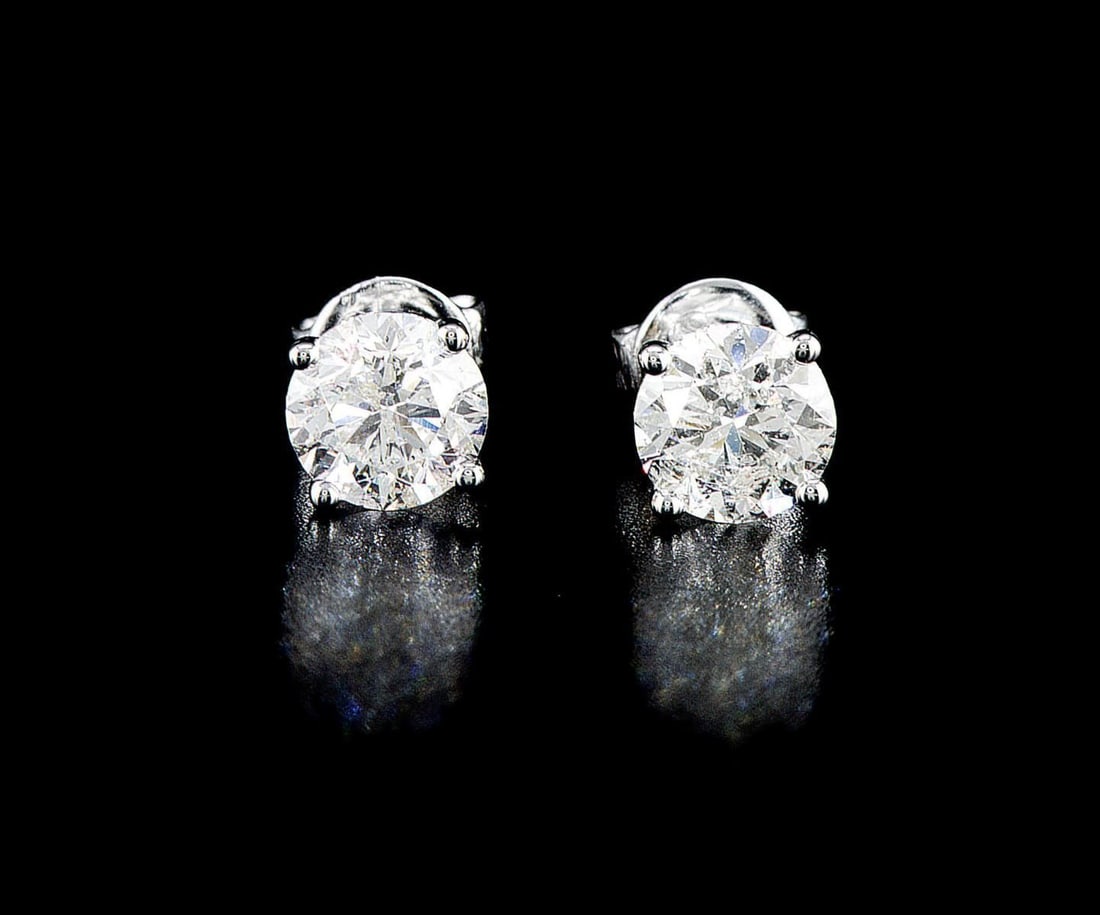 14kt White Gold 2.12ctw Diamond Earrings: One pair of 14k white gold earrings (585 stamped), each set with one natural enhanced diamond. Jewelry Weight: 1.81Grs Total Diamonds Weight: 2.12Cts Main Stones Description: Quantity: 2 Cut and shape