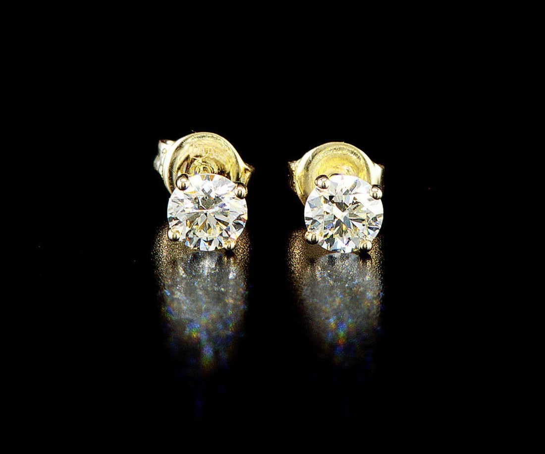 14k yellow gold 1.07ctw Diamond Earrings: One pair of 14k yellow gold earrings (585 stamped), each set with one natural diamond. Jewelry Weight: 1.32Grs Total Diamonds Weight: 1.07Cts Main Stones Description: Quantity: 2 Cut and shape: Round 