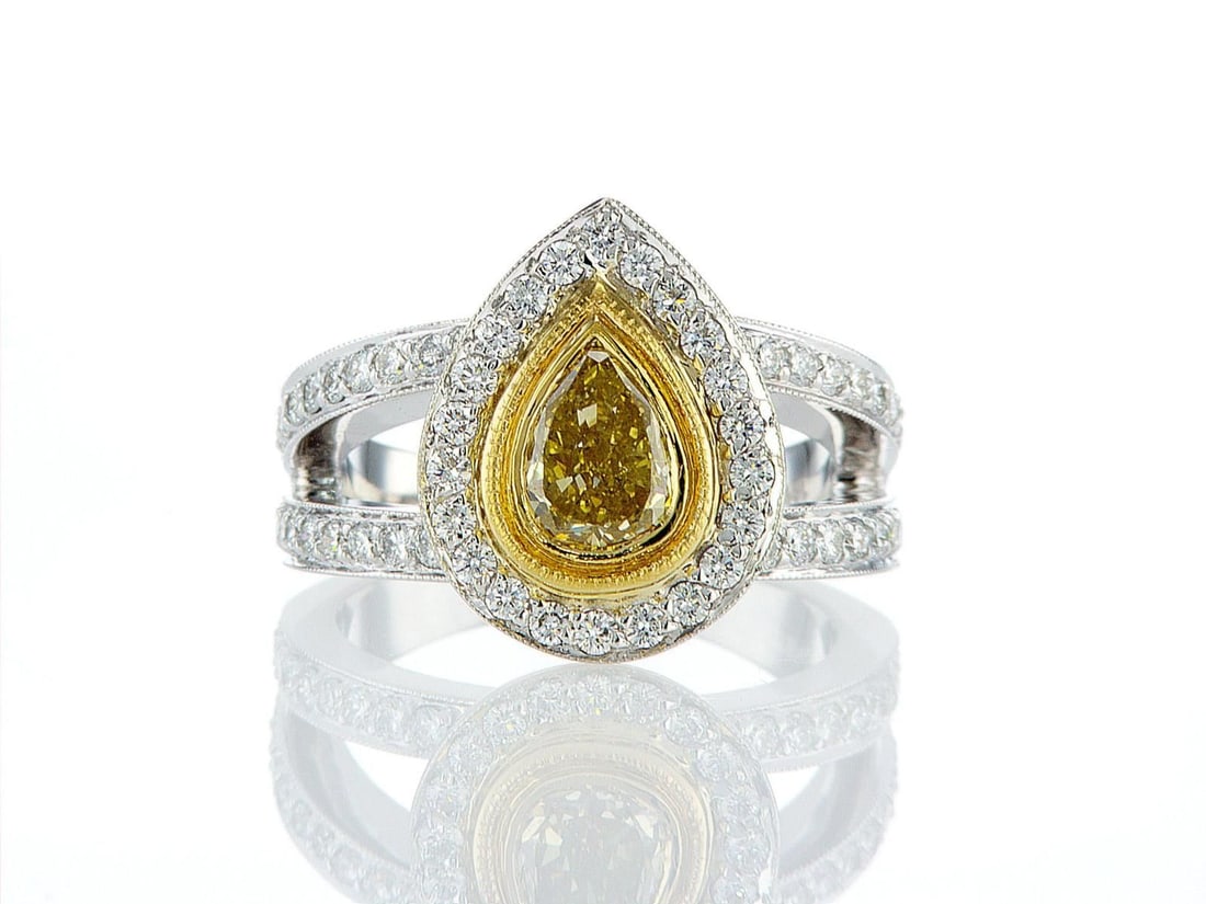 18kt White and Yellow Gold 2.15ctw Diamond Ring: One 18k white and yellow gold ring (18k stamped), set with one center natural diamond and small natural diamonds around and on the sides. Jewelry Weight: 10.28Grs Total Diamonds Weight: 2.15Cts Main S