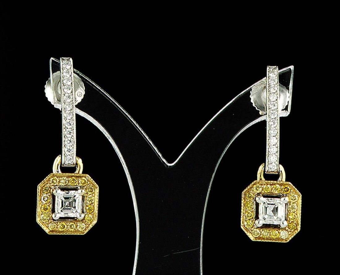 18kt White & Yellow Gold 1ctw Diamond Earrings: One pair of 18k white & yellow gold earrings (750 stamped), each set with one center natural diamond and small natural diamonds around. Jewelry Weight: 4.96Grs Total Diamonds Weight: 1Cts Main Stones 