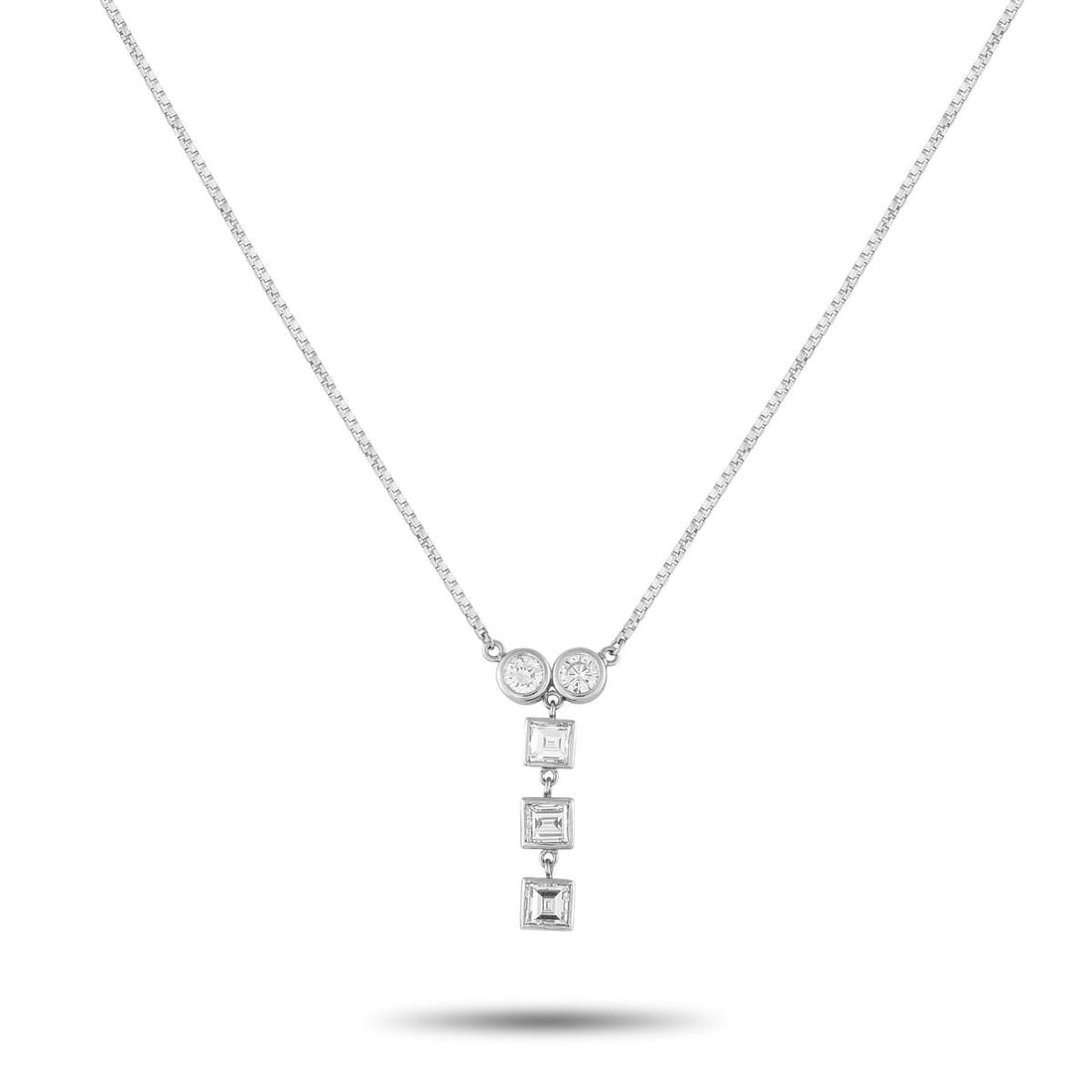 PLATINUM 1.41CT DIAMOND NECKLACE: Circles meet squares in this diamond necklace. The pendant begins with two bezel-set round diamonds side by side, their radiant shine giving way to a vertical drop of three square-cut diamonds in slee