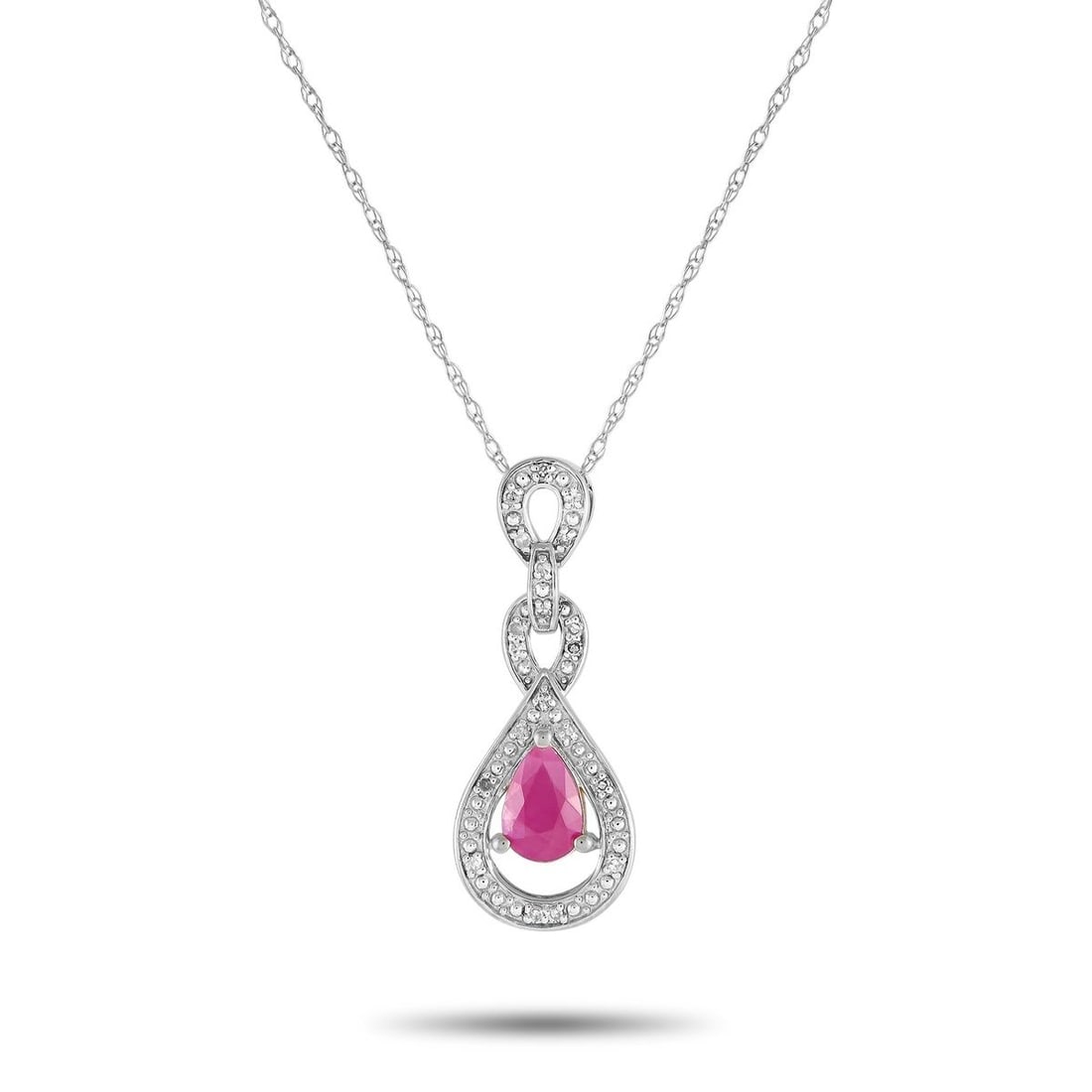 14K WHITE GOLD 0.08CT DIAMOND AND RUBY NECKLACE: This 14K white gold necklace will continually capture your imagination. The intricate pendant measures 0.85 long by 0.45 wide and is suspended from a delicate 18 chain. Sparkling diamonds with a total