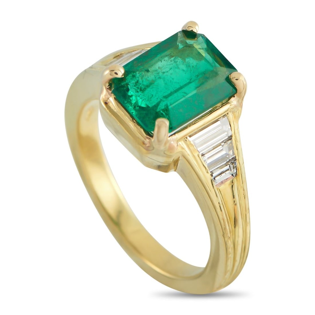 18K YELLOW GOLD 0.45CT DIAMOND AND EMERALD RING: This luxury ring offers clean lines and a classic sense of sophistication. A 1.95 carat Emerald makes a statement at the center, while Diamonds totaling 0.45 carats add a touch of traditional sparkle.