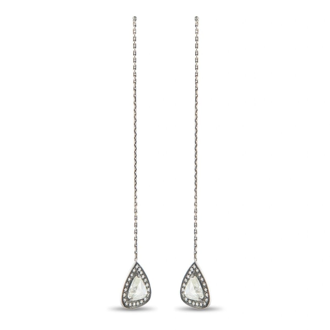 14K WHITE GOLD 3.23CT DIAMOND DANGLE EARRINGS: A striking pair of long drop earrings in 14K white gold, each suspending a pear-shaped halo pendant from a delicate link chain. Each pendant centers a large trillion-cut diamond framed by a milgrain-b