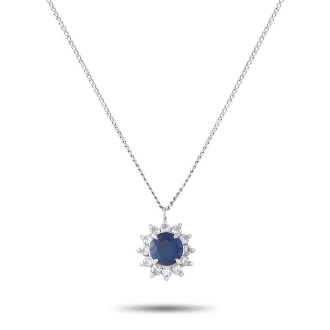 PLATINUM 0.36CT DIAMOND AND SAPPHIRE PENDANT NECKLACE: This Platinum necklace will effortlessly complement any ensemble. A round-cut 1.06 carat Sapphire makes a statement at the center, while Diamond accents totaling 0.36 carats add extra sparkle. The pen