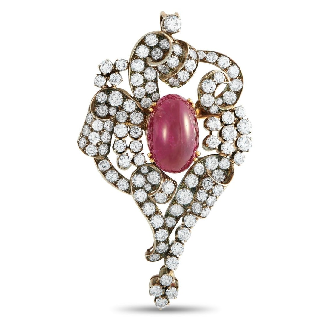 18K YELLOW GOLD AND SILVER 6.25CT DIAMOND AND RUBY BROOCH: This brooch invites a closer look to fully appreciate the intricate harmony of its fiery ruby heart and icy diamond trails. It centers on an 11.0-carat oval ruby cabochon, its domed surface grounding 