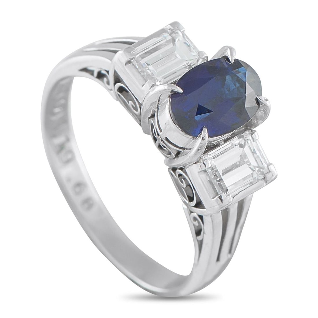 PLATINUM 0.68CT DIAMOND AND SAPPHIRE THREE-STONE RING: This ring's beauty lives in the contrast of color and brilliance, sharp form, and timeless appeal. It features a 1.19-carat oval sapphire framed by emerald-cut diamonds, rising on a platinum band with