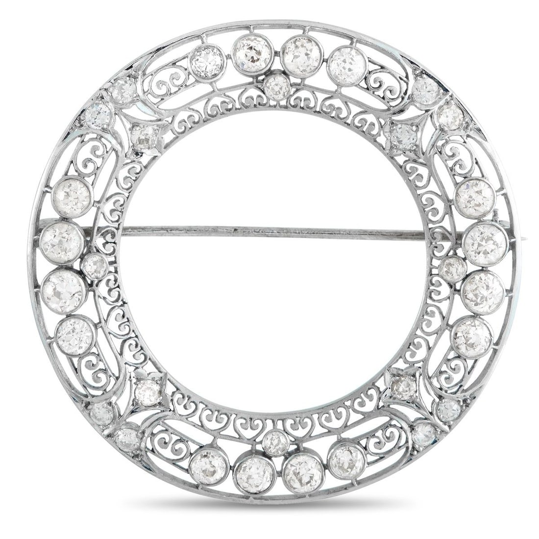 PLATINUM 3.75CT DIAMOND WREATH BROOCH: A continuous ring of light. This Edwardian-style brooch is designed like a wreath, with lace-like filigree, pierced and patterned with repeating motifs. Round diamonds are embedded in smooth, circular