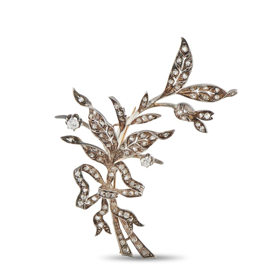 ANTIQUE 18K ROSE GOLD AND SILVER 1.0CT DIAMOND FLORAL LEAF BROOCH: An exquisite antique French brooch crafted in 18K rose gold and sterling silver, depicting a naturalistic spray of leaves and branches tied with a ribbon bow, the entire surface pav-set with old mine 