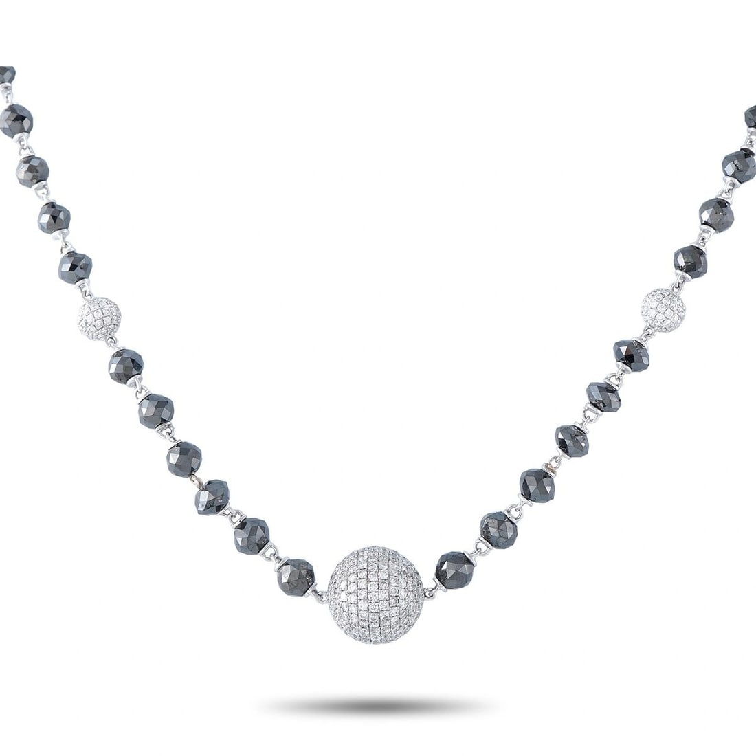 18K WHITE GOLD 47.25CT WHITE AND BLACK DIAMOND BEADED NECKLACE: This necklace is crafted from 18K white gold and designed as a strand of faceted black diamond beads accented by three diamond-set pav stations. It features approximately 3.25 carats of white diamonds