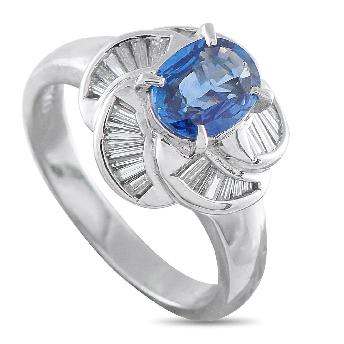 PLATINUM 0.43CT DIAMOND AND BLUE SAPPHIRE PINWHEEL HALO RING: The design of this ring delivers a beautiful sense of motion and intense brilliance. At its heart is a rich blue 1.10-carat oval sapphire, encircled by an innovative pinwheel halo composed of tapering