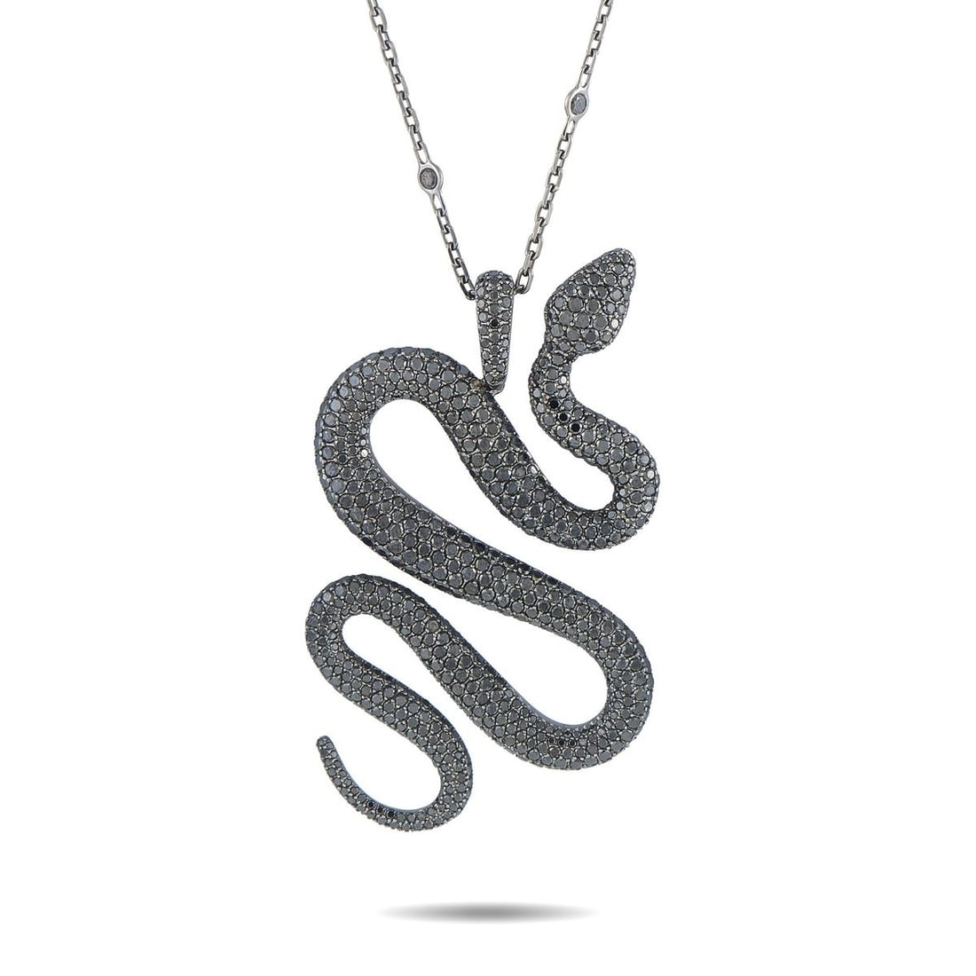 MESSIKA 18K WHITE GOLD BLACK DIAMOND SNAKE PENDANT NECKLACE: A bold, dramatic design makes this Messika necklace incredibly eye-catching. Crafted from 18K White Gold, the stunning snake pendant is elevated by a dazzling array of Black Diamonds. The pendant meas