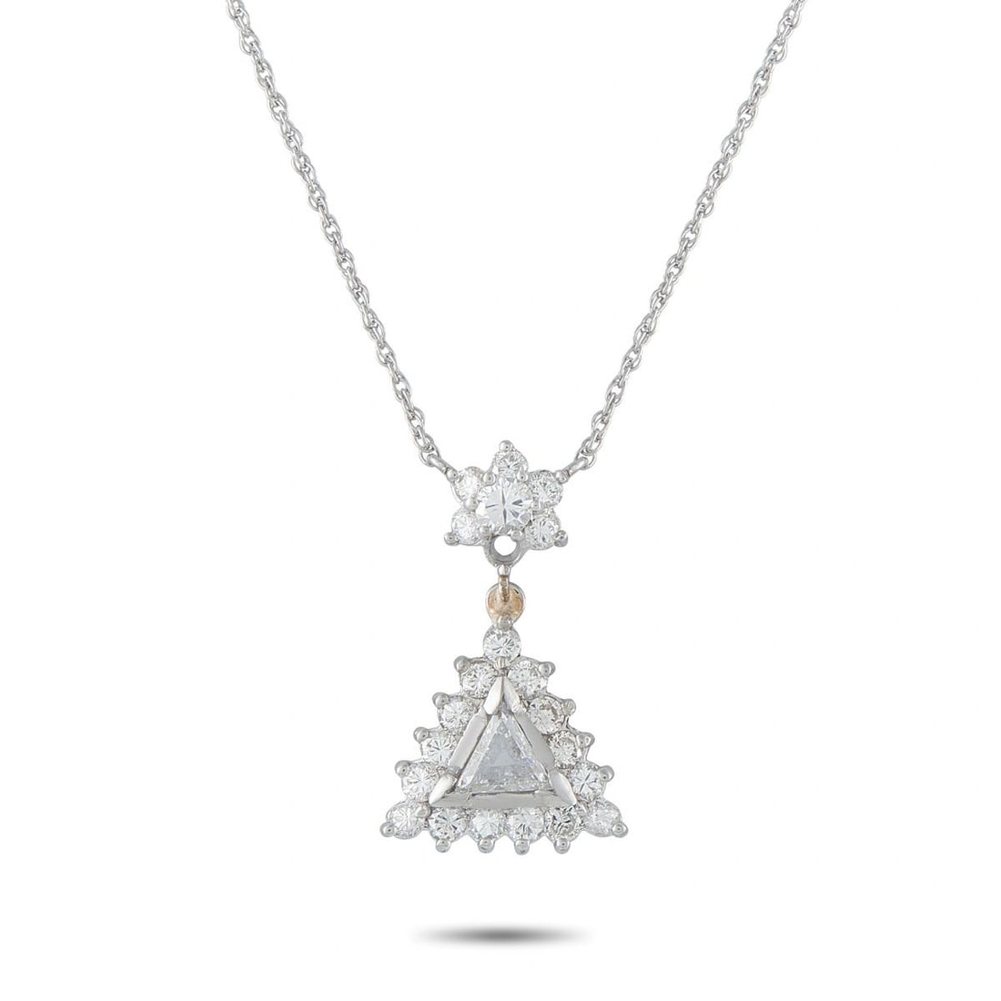 14K WHITE GOLD 1.25CT DIAMOND TRIANGULAR HALO PENDANT NECKLACE: A striking pendant necklace in 14K white gold, centering a trillion-cut diamond within a triangular diamond halo. The pendant is suspended from a diamond flower cluster connector accented with a