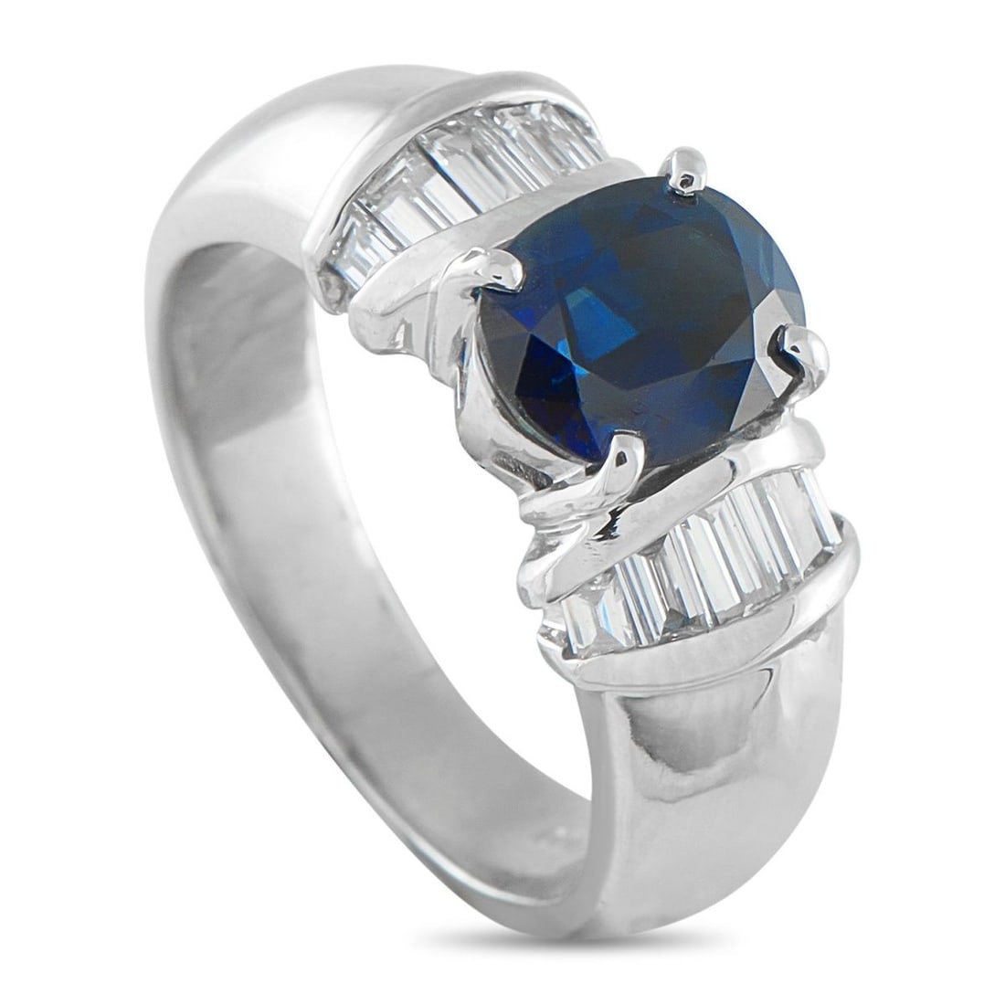 PLATINUM 0.46CT DIAMOND AND SAPPHIRE RING: A spectacular 2.18-carat oval sapphire takes center stage, held securely by four classic prongs. Flanking the rich blue center stone are neat collars of baguette diamonds, set within a contemporary