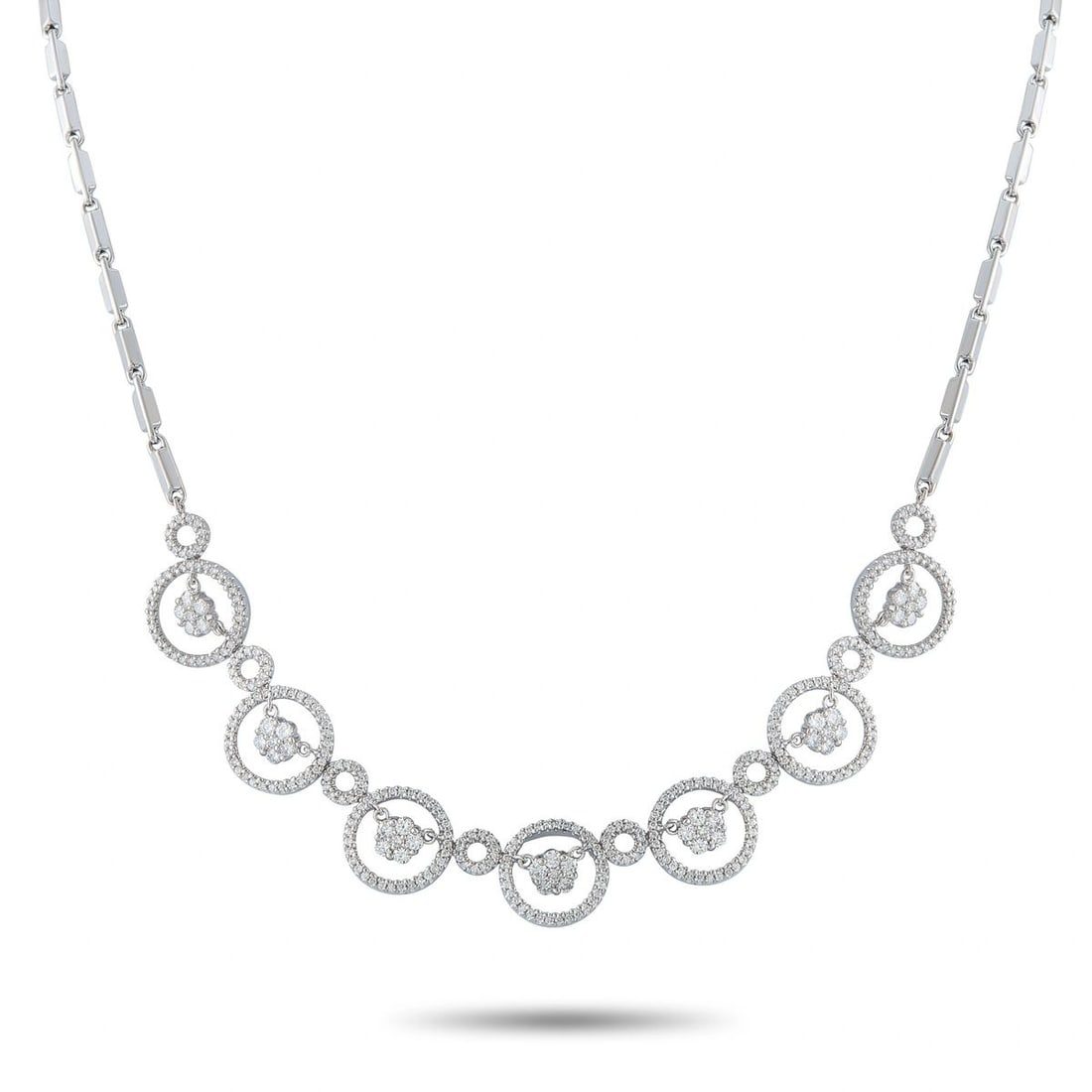 18K WHITE GOLD 2.45CT DIAMOND CIRCLE LINK NECKLACE: This eye-catching necklace is crafted in 18K white gold featuring a series of graduated pave diamond-set open circles, each centered with a dangling floral diamond cluster, joined by smaller diamond-s