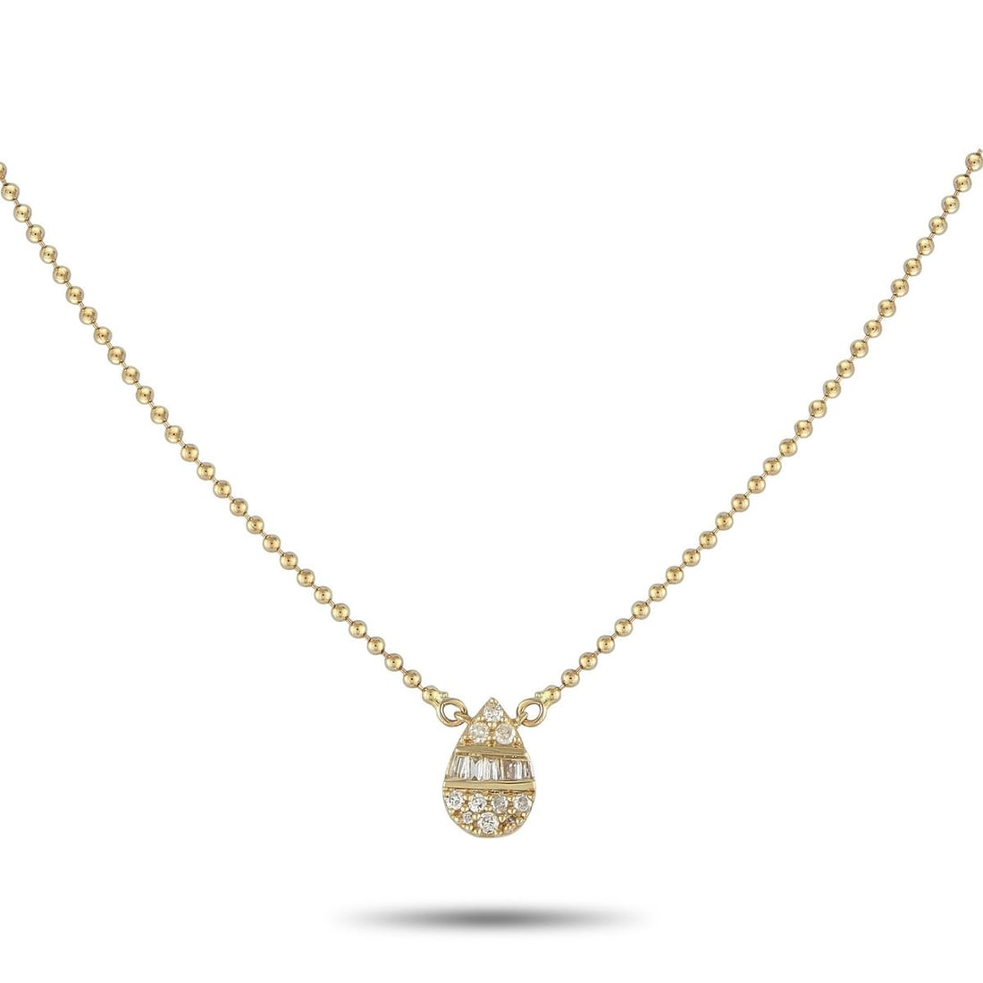 14K YELLOW GOLD 0.11CT DIAMOND PENDANT NECKLACE: Add a touch of sparkle to any ensemble by adding this subtle, sophisticated necklace. A pear-shaped pendant measuring 0.28 long by 0.25 wide is suspended at the center of a 16 ball chain. Diamonds wit