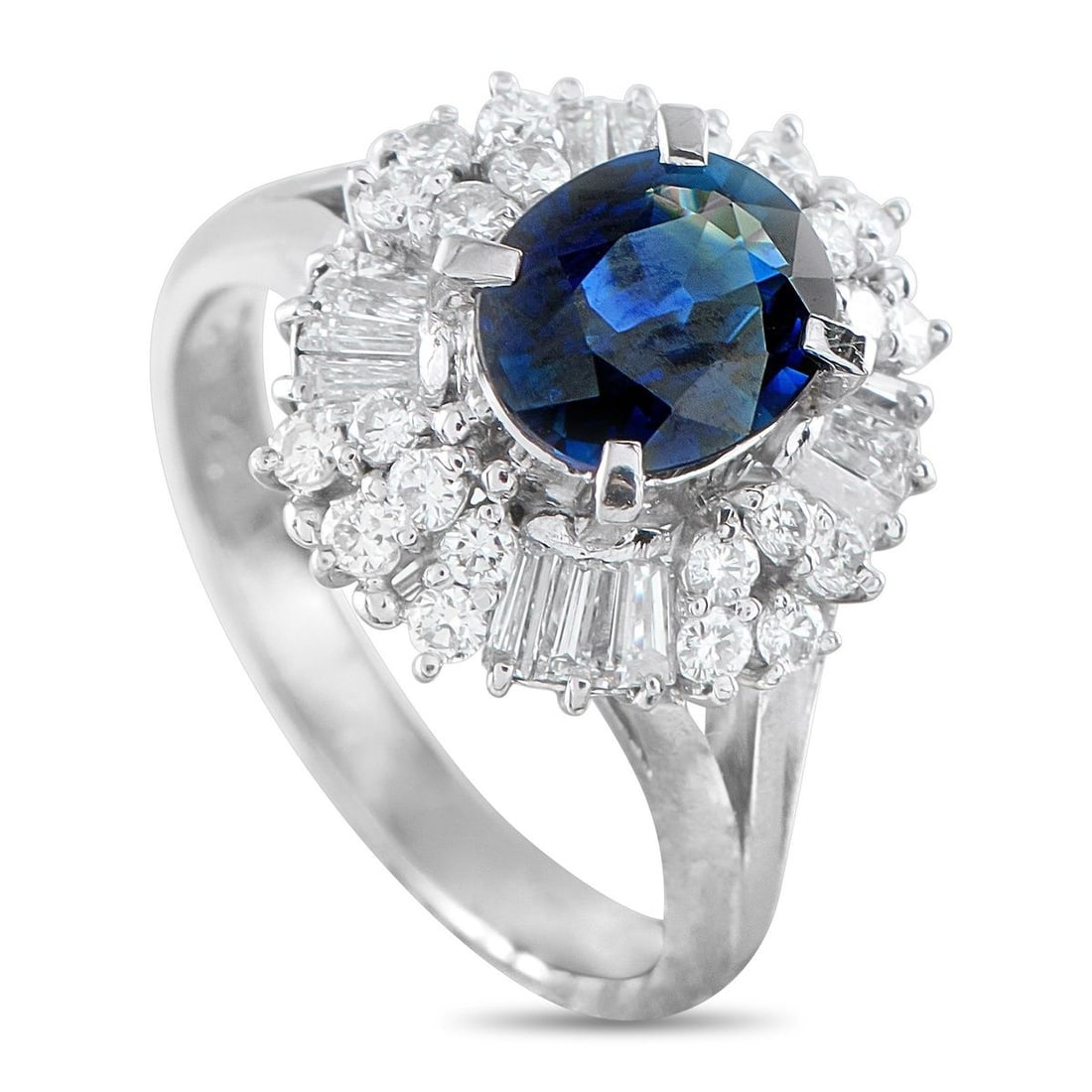PLATINUM 0.82CT DIAMOND AND SAPPHIRE RING: In this ring, the platinum shank rises into double split shoulders, lifting the 1.62-carat sapphire centerstone and diamond halo for maximum visibility and light play. The halo of diamonds alternates