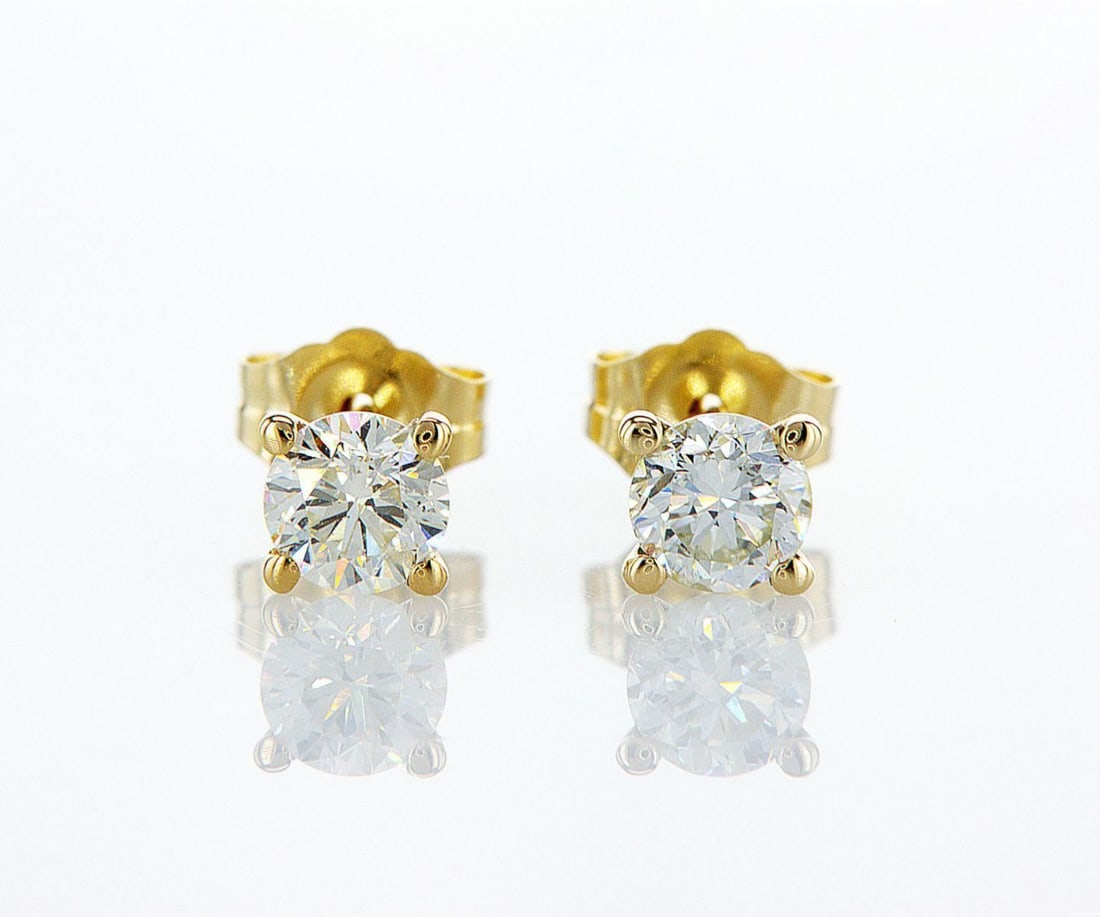 14kt Yellow Gold 0.73ctw Diamond Earrings: One pair of 14k yellow gold earrings (14k stamped), each set with one natural diamond. Jewelry Weight: 0.75Grs Total Diamonds Weight: 0.73Cts Main Stones Description: Quantity: 2 Cut and shape: Round 