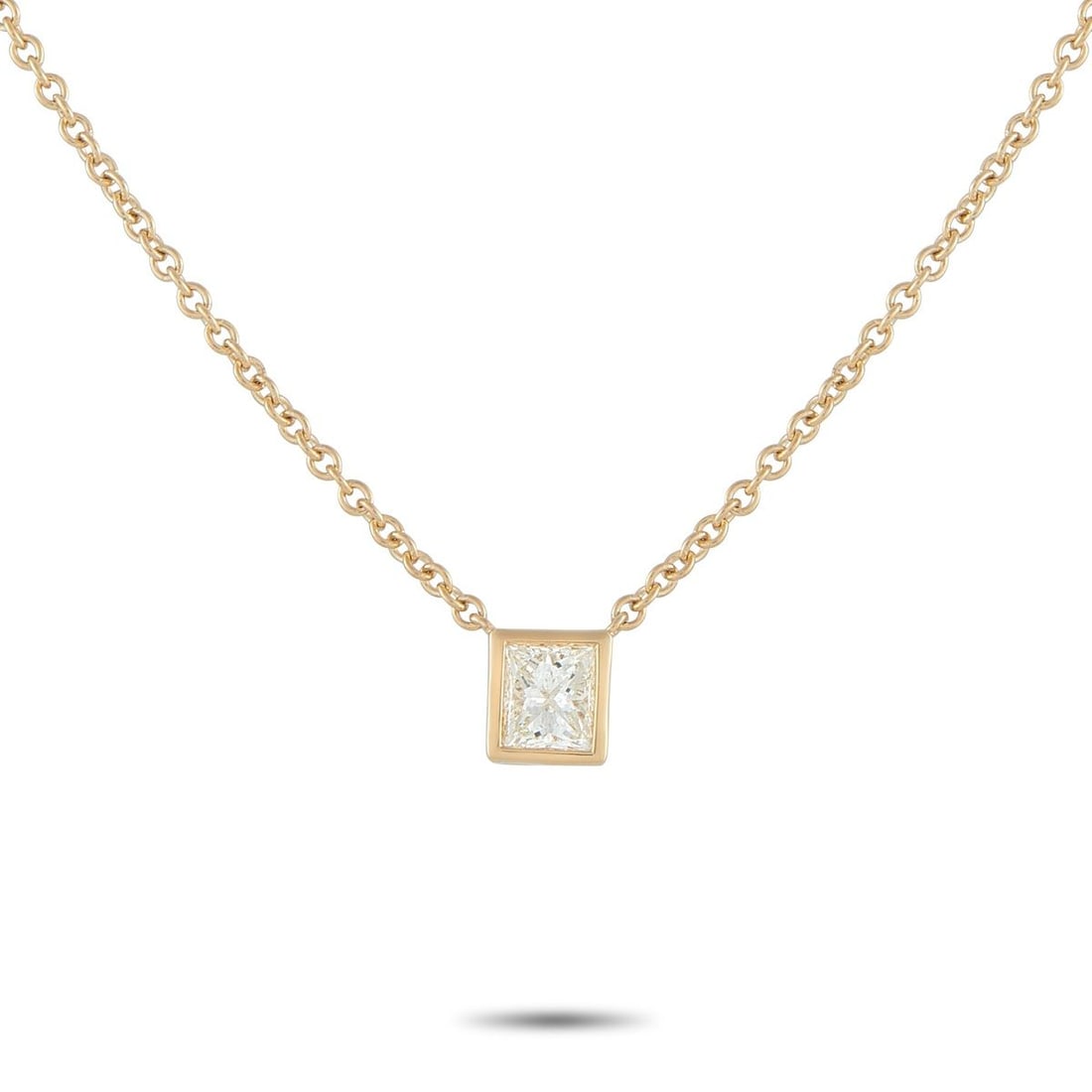 18K YELLOW GOLD 0.60CT PRINCESS-CUT DIAMOND SOLITAIRE NECKLACE: A simple and refined piece perfect for daily wear. A sharp, square princess-cut diamond takes center stage, its facets catching light with crisp, geometric brilliance. It is held securely by a smooth 