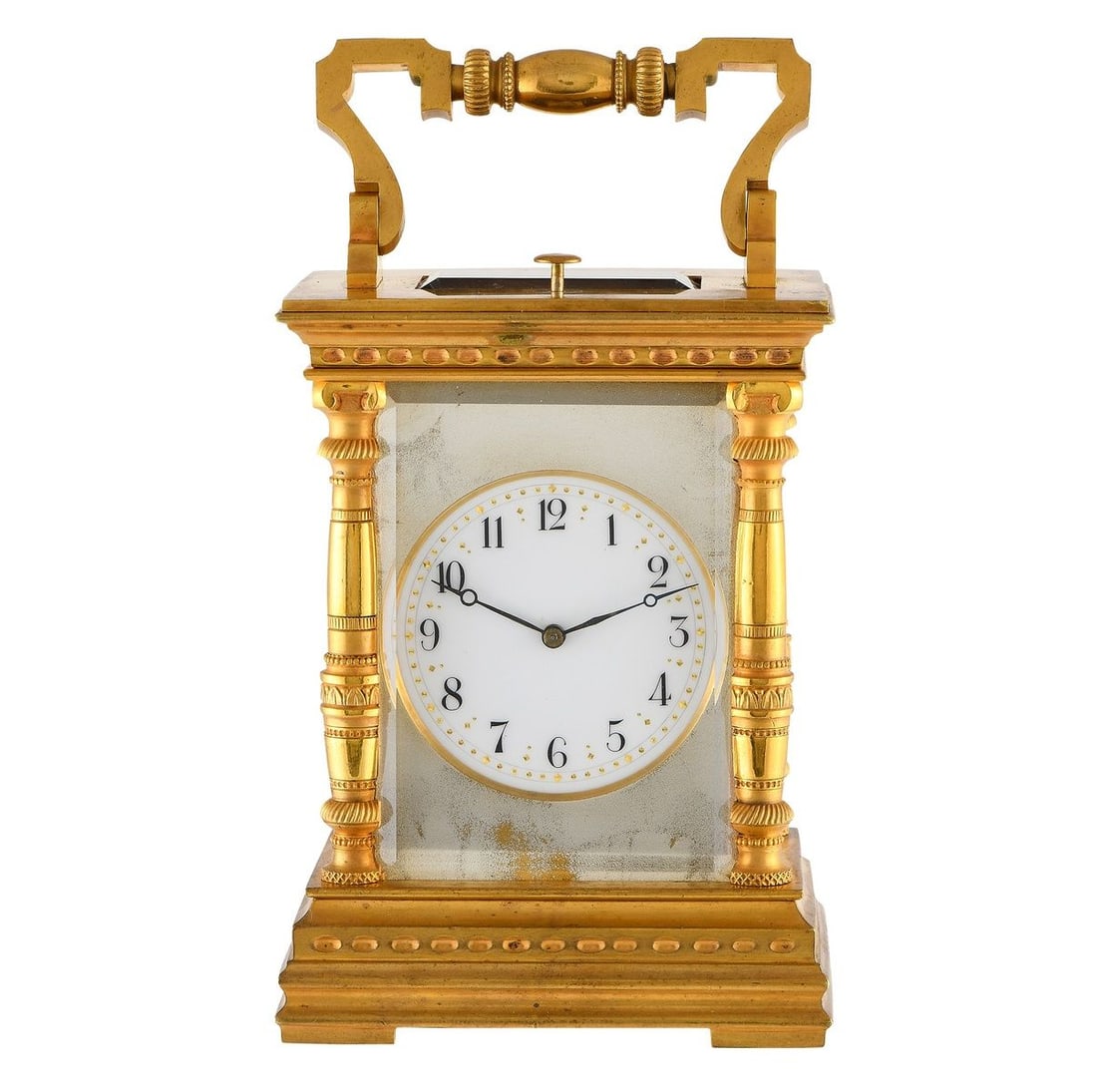 BRASS & ENAMEL BRASS & ENAMEL GILT FRENCH CARRIAGE TABLE CLOCK: Intricately crafted in gilt brass, here is a fine French carriage clock from the late 19th to early 20th century. This analog timekeeper of a discernible style features heavily decorated columns, orna