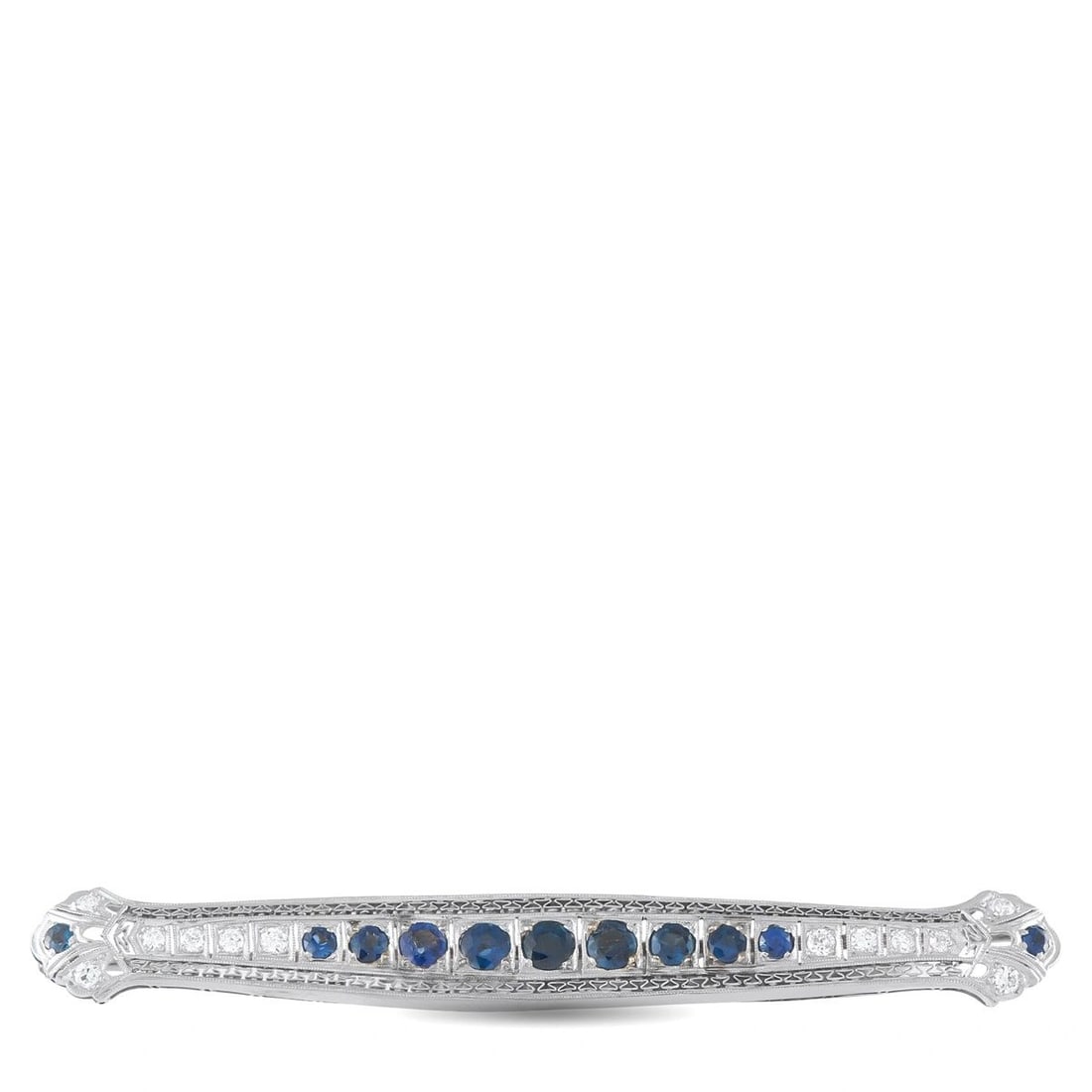 18K WHITE GOLD 0.60CT DIAMOND AND SAPPHIRE ART DECO BAR BROOCH: An elegant Art Deco bar brooch in 18K white gold, featuring a center row of round blue sapphires totaling 2.0 ct flanked by round brilliant diamonds totaling 0.60 ct. Intricate milgrain engraving and 