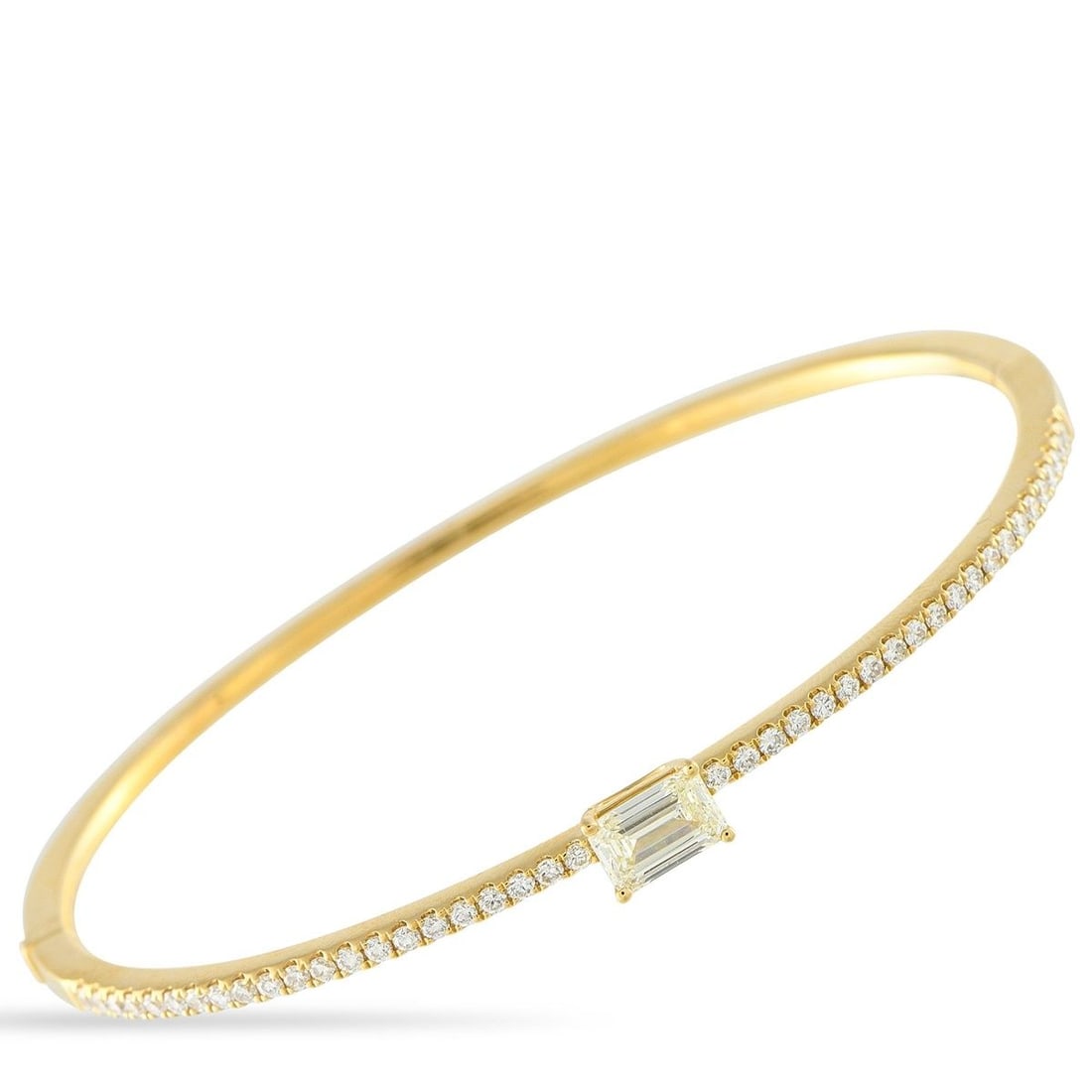 18K YELLOW GOLD 1.30CT DIAMOND BRACELET: This Odelia bangle bracelet is simple, elegant, and endlessly charming. A 0.75 carat Diamond makes a statement at the center of the sophisticated design. Additional Diamond accents totaling 0.55