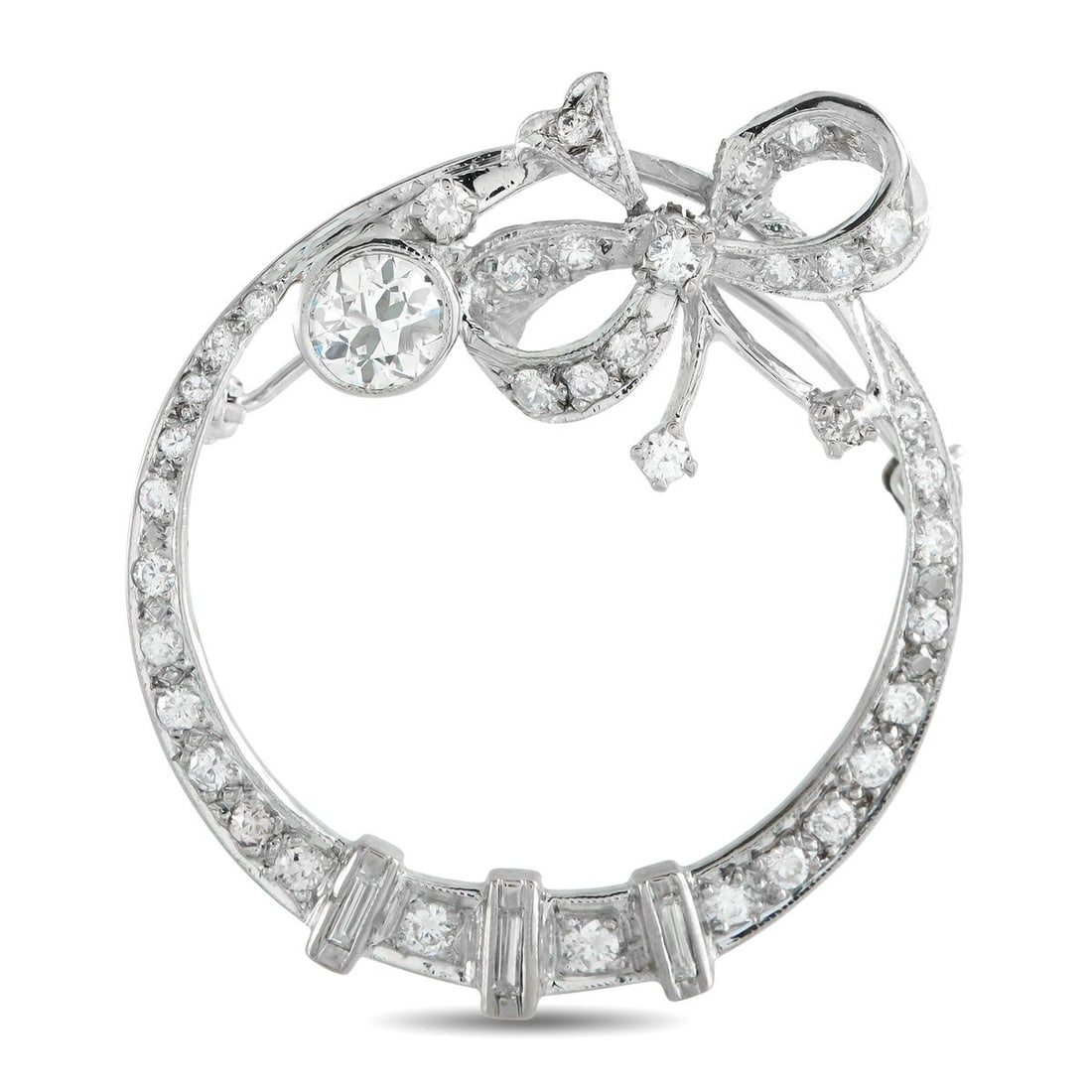 18K WHITE GOLD 1.50CT DIAMOND BROOCH: Intricate metalwork and an openwork design make this brooch an instant classic. Crafted from 18K White Gold, the circular setting is elevated by a charming bow motif. Diamonds with a total weight of 1
