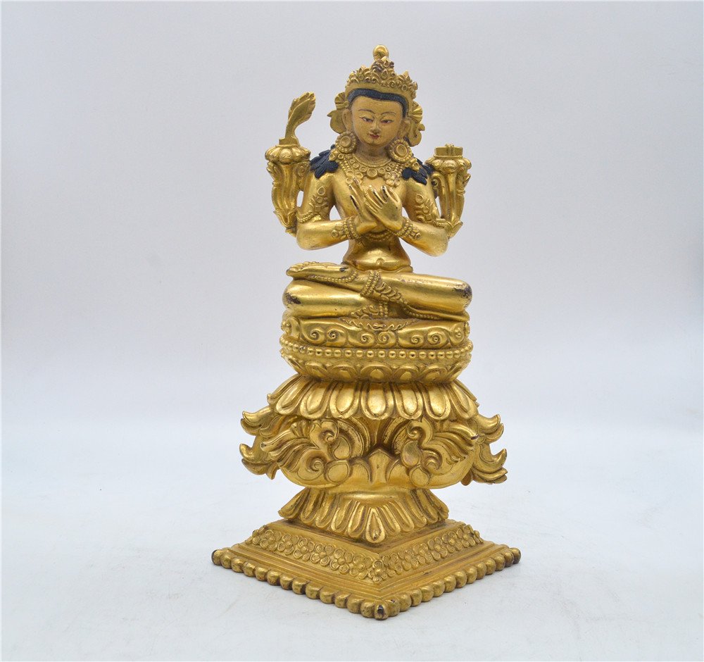GILT BRONZE MANJUSHRI SEATED FIGURE: The gilt bronze figure depicts Manjusri seated on tall double tiered pedestal and lotus throne in dhyanasana, hands raised at chest level in mudra, lotus flowers stems from the arms, wearing decoratio