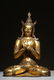 LARGE GILT BRONZE SEATED FIGURE