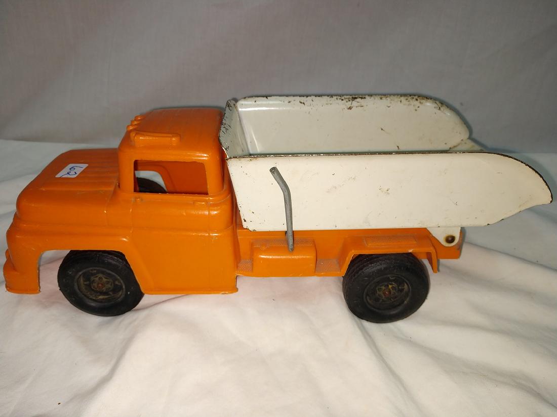 Buddy L Dump Truck: 12 3/4"L x 4 3/4"W x 4 1/2"H. Plastic Body Tin Bed Dump Truck. Paint loss on bed.