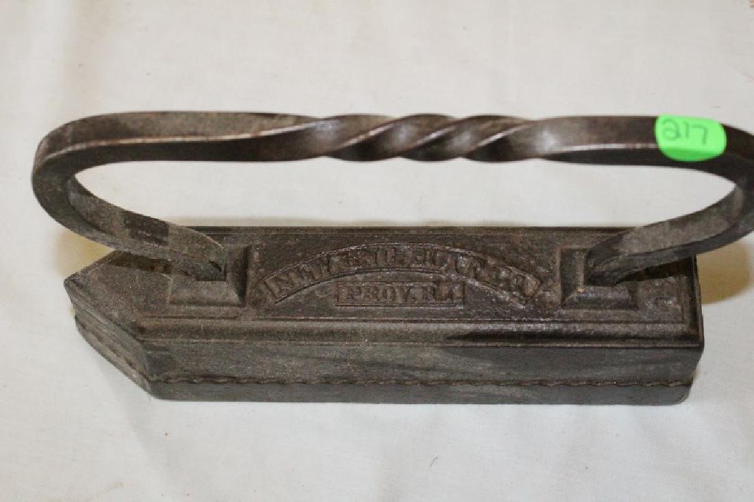 Iron - Sad Iron: New England Bott Co. Providence, RI. Sad Iron; Twisted Handle. 10" L X 2" W X 6 1/2" H.