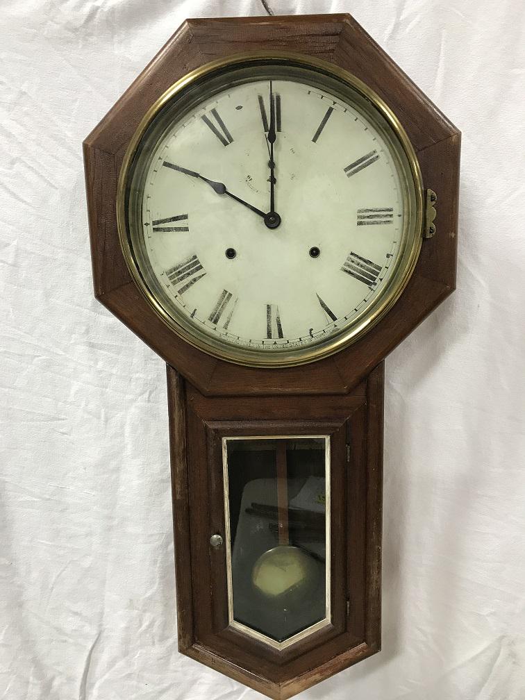 Clock - Seth Thomas Company Clock: Wall Clock. Original zinc tin face. Roman numerals and outside border faded and worn. Still very readable. Has brass level strip at bottom of pendulum. Second hand numbers and border are very faded bu
