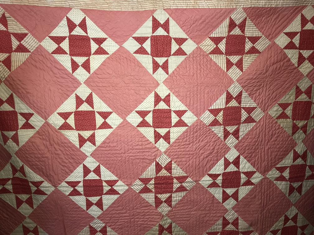 Quilt - Ohio Star on Point: Late 1800-Early 1900's. Red Striped Border, 8 pt. Square, Feed sack back. End sewn by tredal machine.