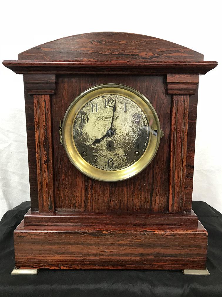 Clock - Seth Thomas Sonora Chime: Sonora Chime Clock. Red adamantine Veneer Cabinet. Original zinc tin face. Brass feet on cabinet. 4 Bell Chime. Back removes easily to get workings of clock. Lever on back corner to turn chimes on or