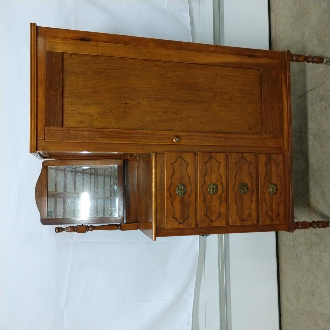 Furniture - Chifforobe: 4 Drawer Chifforobe, arched topped mirror on side of drawers. Right side has large door that opens to clothes/storage area. Clothes hanger stick in top, solid panel door. Turned legs on rollers. Brass