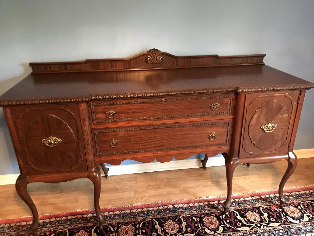 Furniture - Mahogany Sideboard: Mahogany Sideboard, 2 drawers in middle, 1 open door on each side. Beading around drawers. Original pulls on drawers. Queen Anne feet with rollers. Has 2 keys. Top drawer has lock.