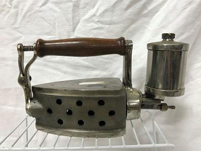 Iron - Revolving Alcohol Iron: Iron has two faces. Handle rotates so you can use either side. Internal workings are removable. Nice wood handle.