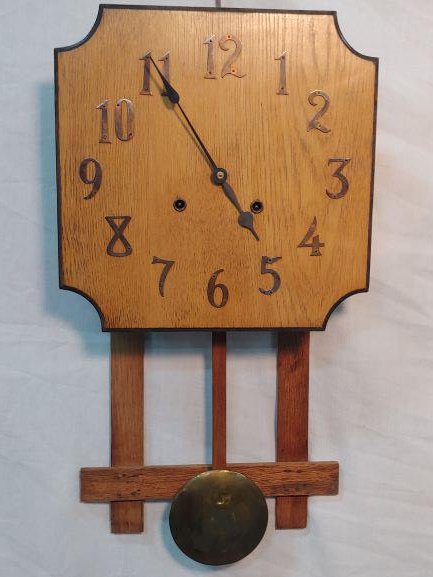 Clock - Oak Mission Style Wall Clock: Oak Mission Style Wall Clock. Brass covered weight on Pendulum. Maker unknown.