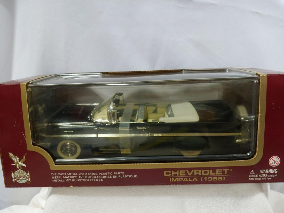 Die Cast Car - 1959 Chevrolet Impala Convertible: Die Cast Car. 1/18 scale in original unopened box. 1959 Chevrolet Impala Convertible. Black in color with white top & interior. In original unopened box and display stand.