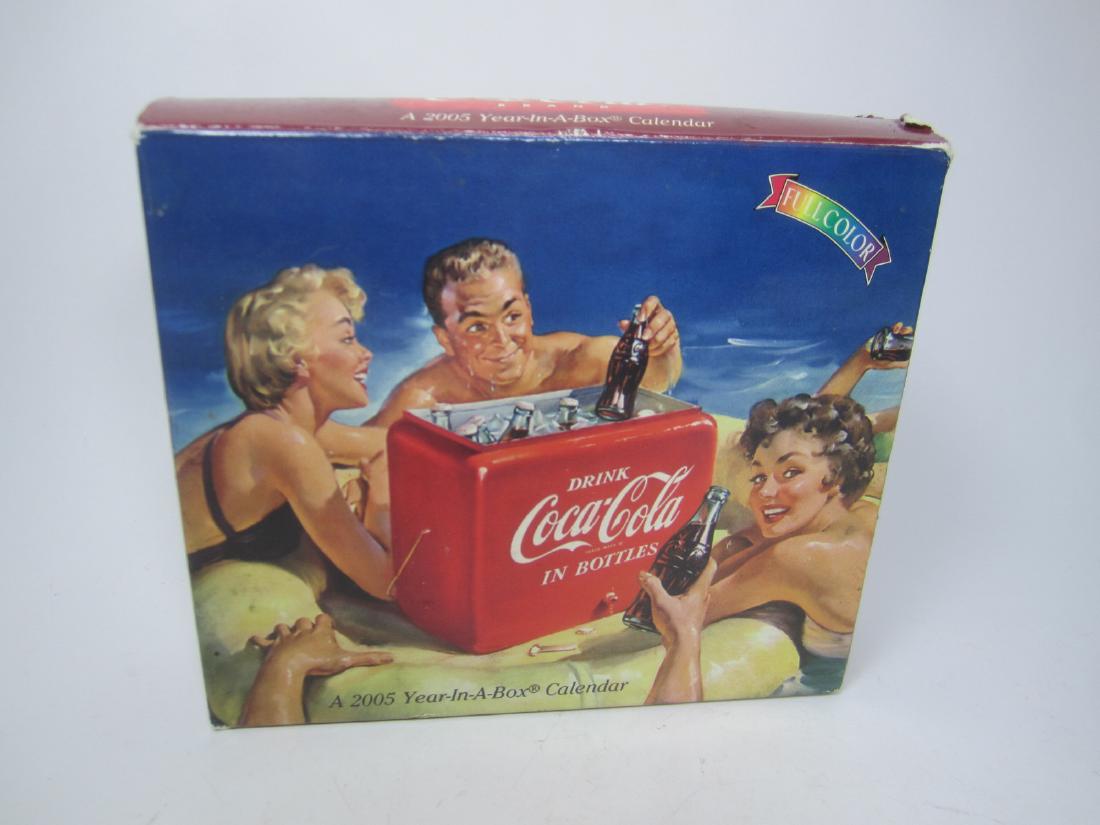 A COCA-COLA 2005 YEAR-A-BOX CALENDAR.: A Coca-Cola 2005 Year-A-Box Calendar. 6"X5.5"X1.5"