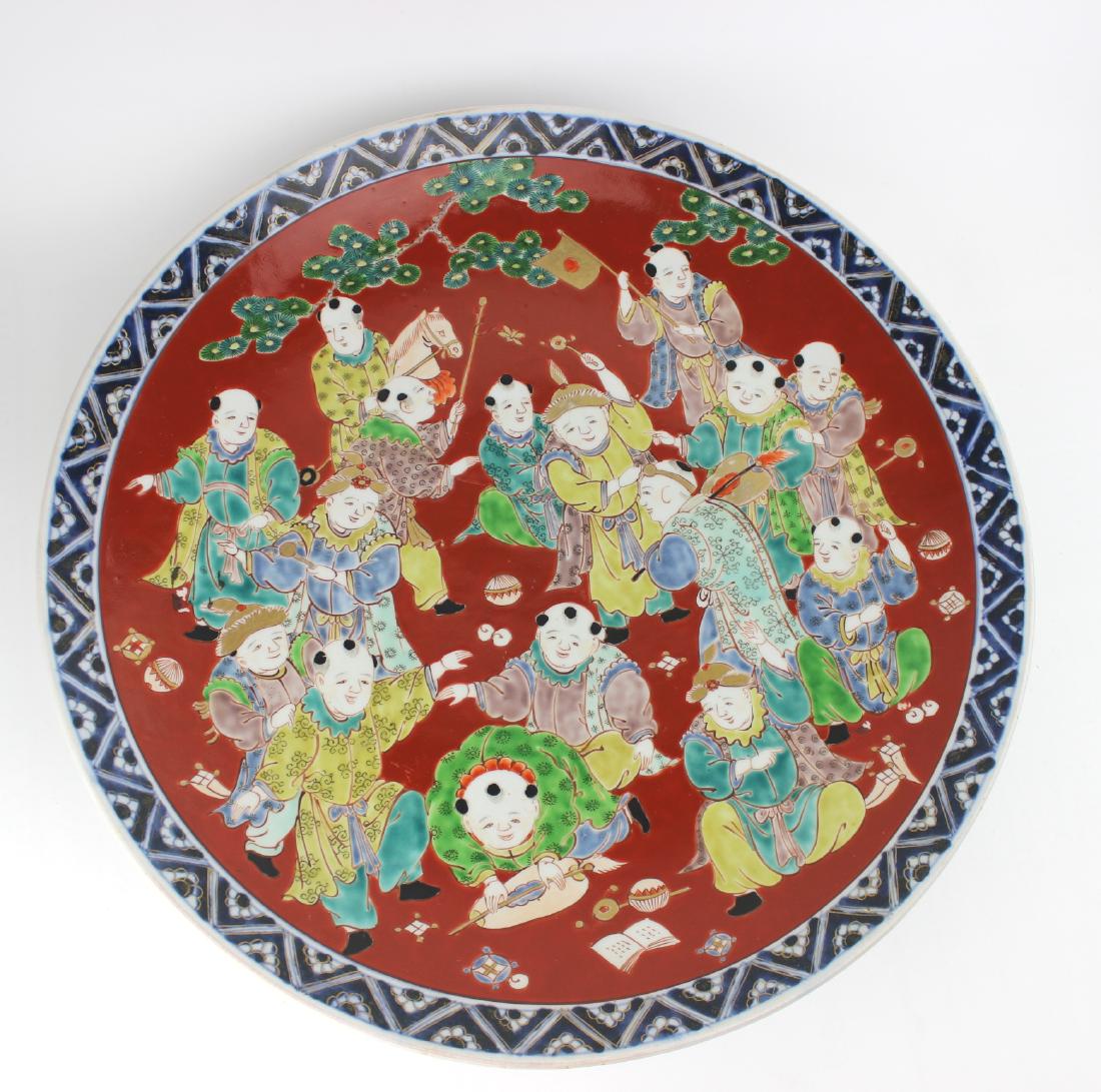 ASIAN FAMILLE VERTA CHARGER: Depicting kids playing. One long hairline on central bottom. Small chips to rim. 16.5"D.