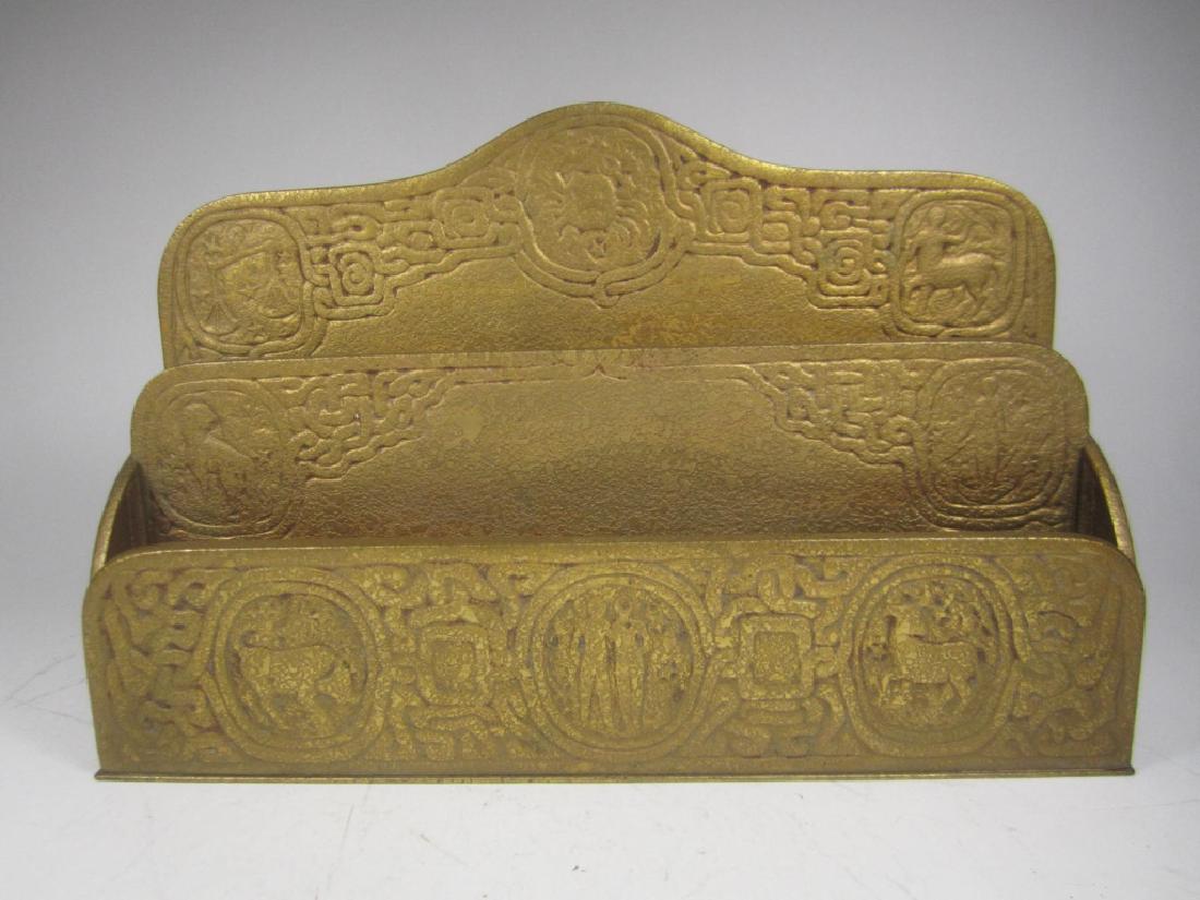 TIFFANY STUDIOS #1009 GILT ZODIAC LETTER HOLDER: This antique zodiac letter holder with two-slot displays gold finish. Stamped: Tiffany Studios/ New York/ 1009. In good condition. Size: 6.0"X9.5"X2.5".