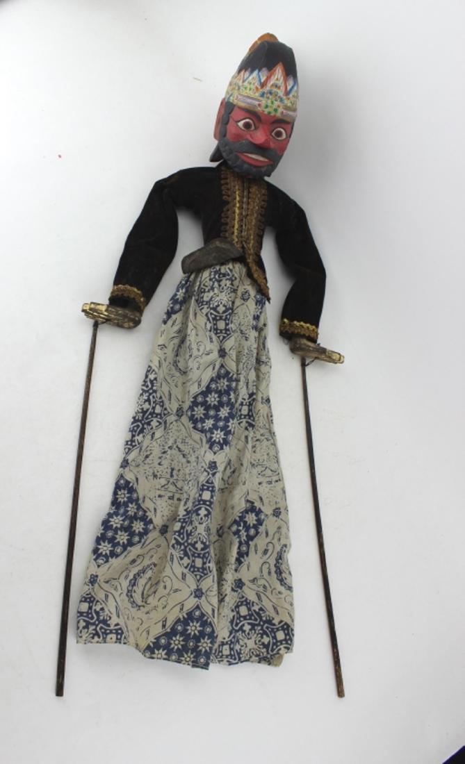 AN INDONESIA PUPPET: With a double faces wood head. 28 in. H.