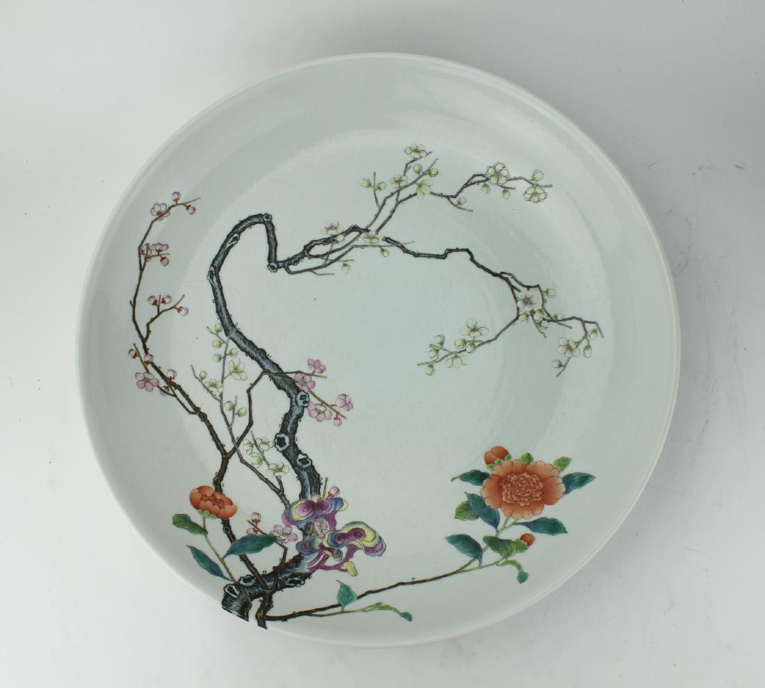 A CHINESE FAMILLE ROSE ENAMELED CHARGER: The charger with Cross edge design of branches having colorful blossoming flowers, shallow bowl form, marked with the Yongzheng reign mark (1723-1735) The charger with slight surface scratches commens