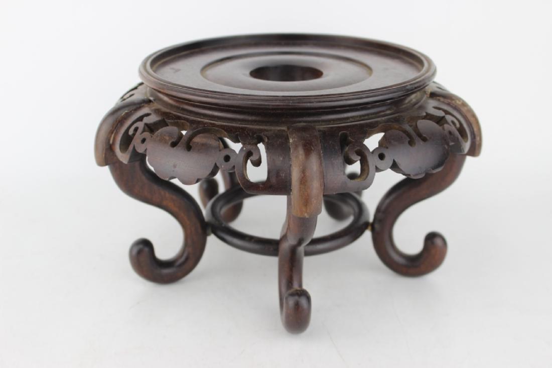 A CHINESE WOOD STAND: 9 1/2 in. (D) X 5 1/2 in. (H).
