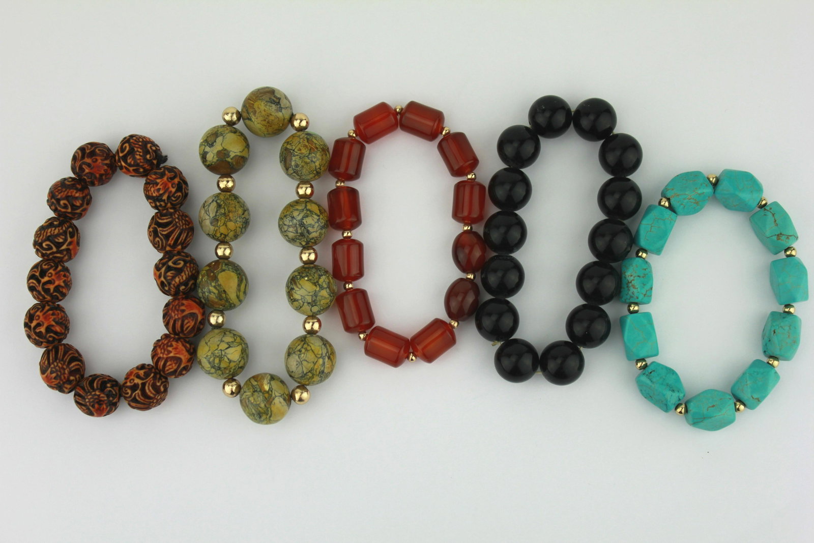 A LOT OF FIVE ASSORT BRACELETS: Includes agate, black stone, carved nuts, and turquoise etc. The bead is about 15 mm in diameter.